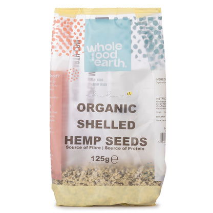 Organic shelled hemp seeds from Whole Food Earth, showing small, greenish seeds in a clear container, ideal for healthy snacking or cooking.