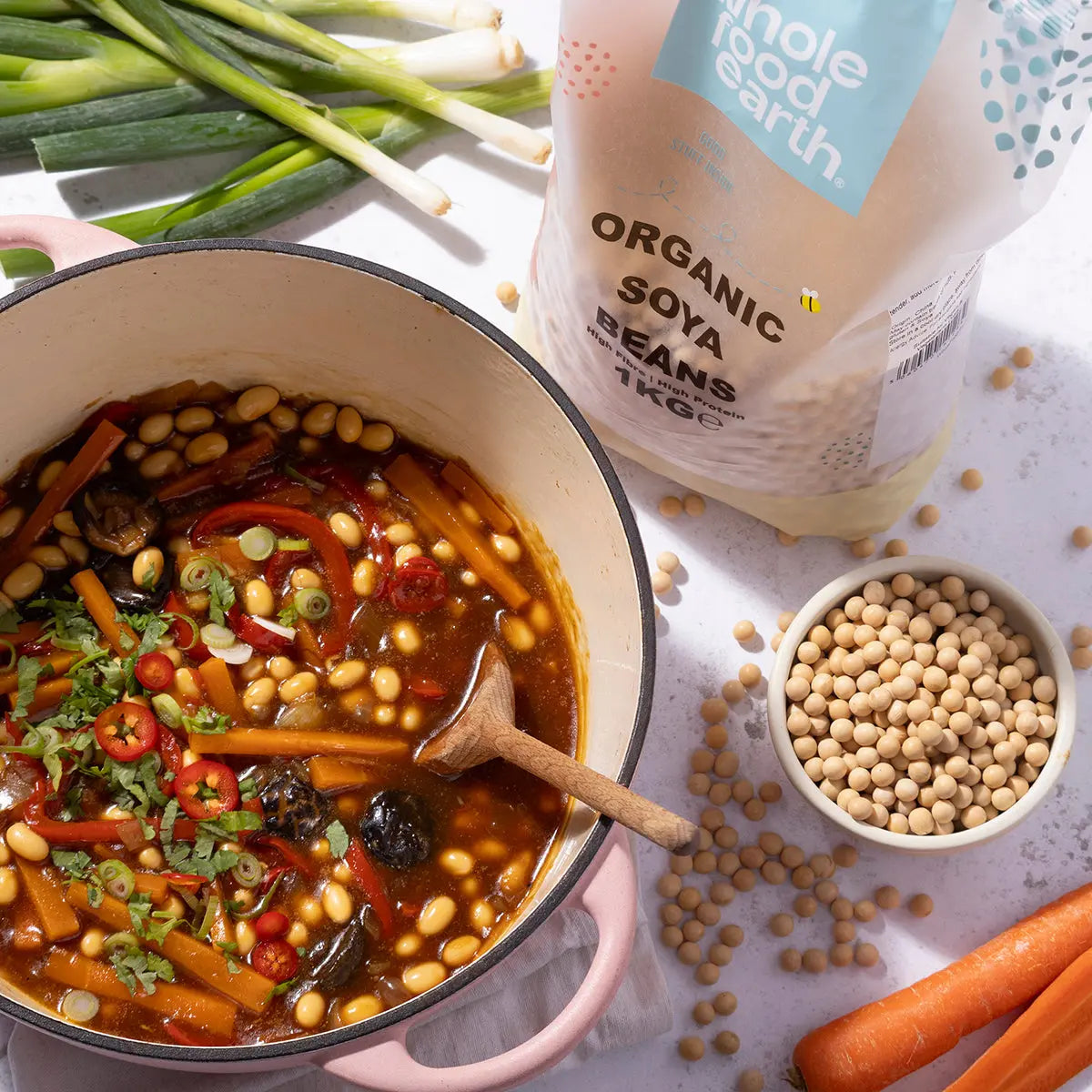 Organic soya beans from Whole Food Earth in a bowl, ready for cooking, on a kitchen counter with fresh ingredients.