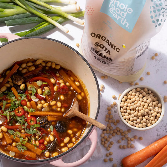Organic soya beans from Whole Food Earth in a bowl, ready for cooking, on a kitchen counter with fresh ingredients.