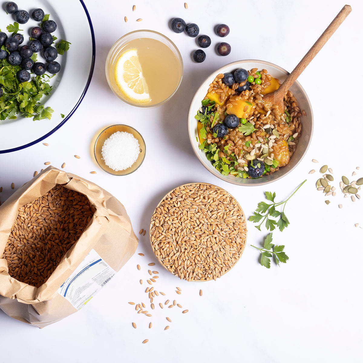 Organic spelt grain from Whole Food Earth, displayed in a rustic bowl with spelt grains spilled around, in a natural kitchen setting.