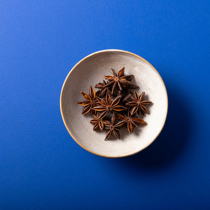 Whole Food Earth organic star anise spice in a 50g package, showcasing the star-shaped spice with multiple pointed pods.