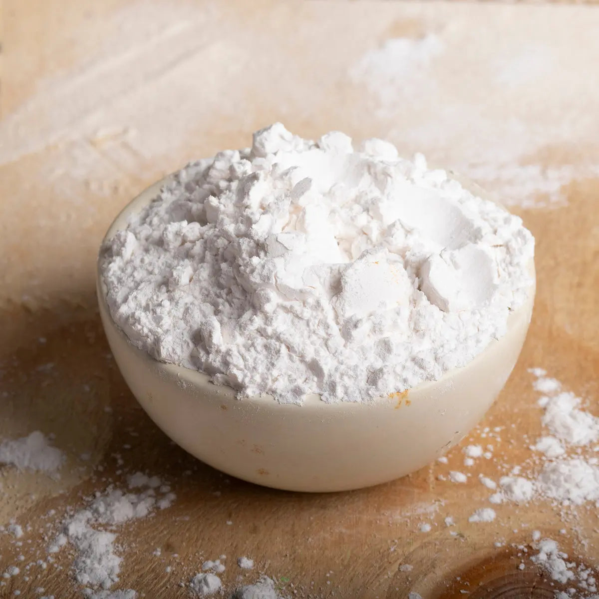 Organic tapioca starch in a clear bowl, showing its fine white powder texture, from Whole Food Earth for gluten-free baking and cooking.