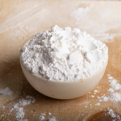 Organic tapioca starch in a clear bowl, showing its fine white powder texture, from Whole Food Earth for gluten-free baking and cooking.