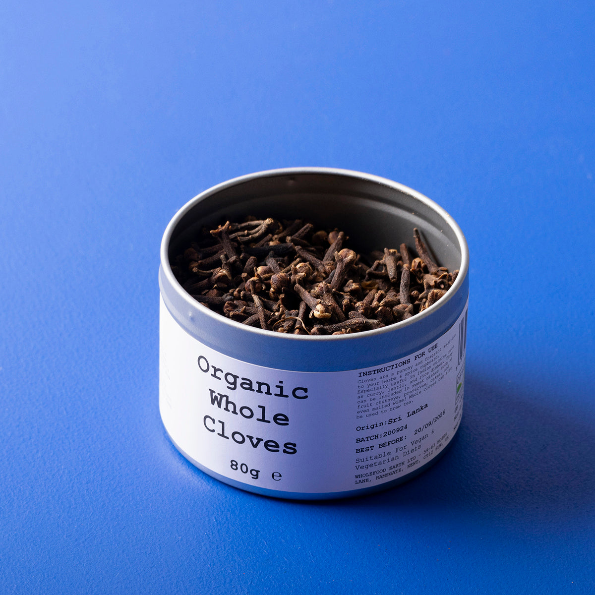 Organic whole cloves from Wild Elephant brand, showing a close-up of dried brown spice bulbs in an 80g package.