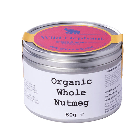 Organic whole nutmeg from Wild Elephant, displayed in a glass jar, showing the brown, textured spice in a natural setting.