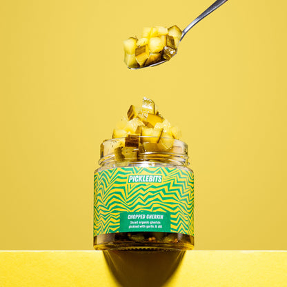 Organic chopped dill pickles by PICKLEBITS in a glass jar, showcasing vibrant green, chopped kosher dill pickles.