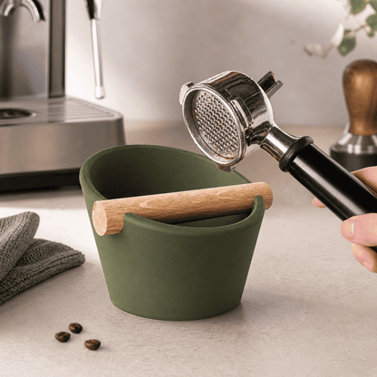 KNOCDIC® oval coffee knock box with real oak wood bar, used for espresso portafilter tamps, in a stylish kitchen setting