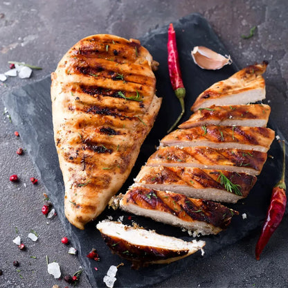 Primrose Herd Creedy Carver free-range chicken breasts, fresh and boneless, displayed on a clean cutting board with natural lighting.