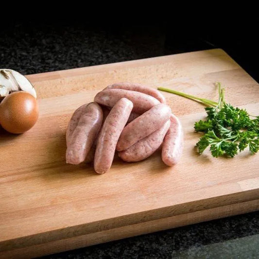 Primrose Herd cocktail sausage variety pack showing an assortment of cooked and raw sausages on a platter.