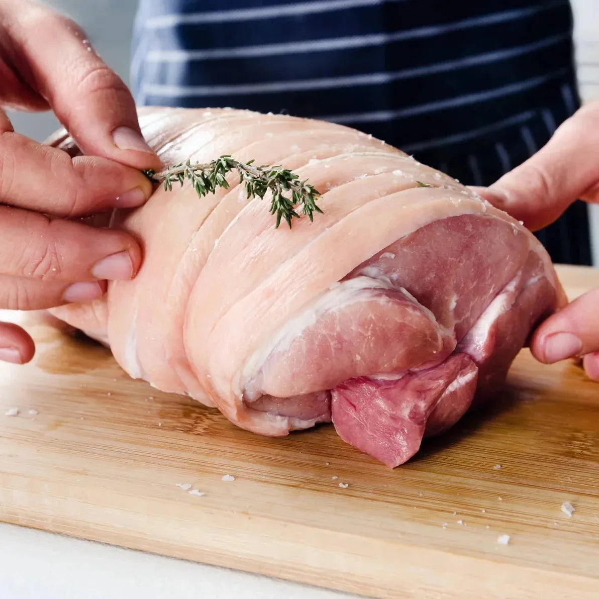 Hand of pork joint from Primrose Herd, showcasing a fresh, raw pork cut with a natural pink color and marbling.