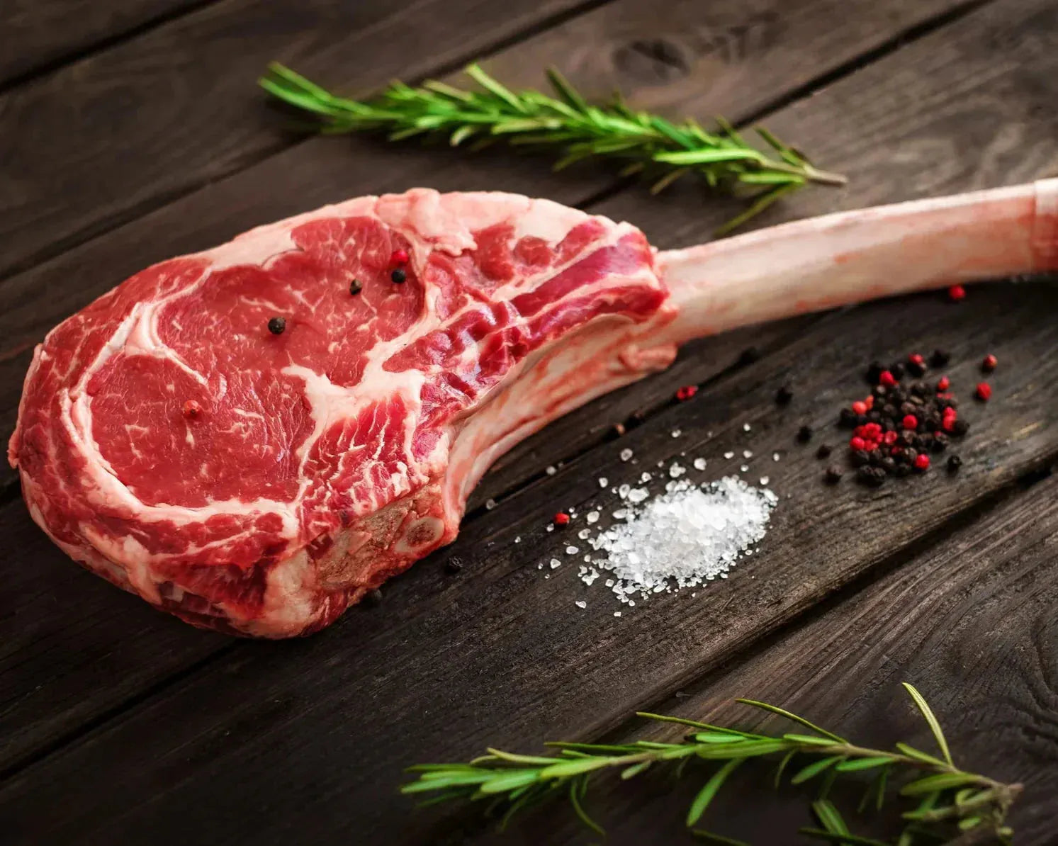 Grass-fed dry-aged beef tomahawk steak from Primrose Herd, 1kg, with thick bone-in cut and rich marbling.