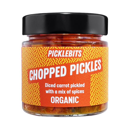 Jar of PICKLEBITS pickled carrots with a vibrant label with black lid.
