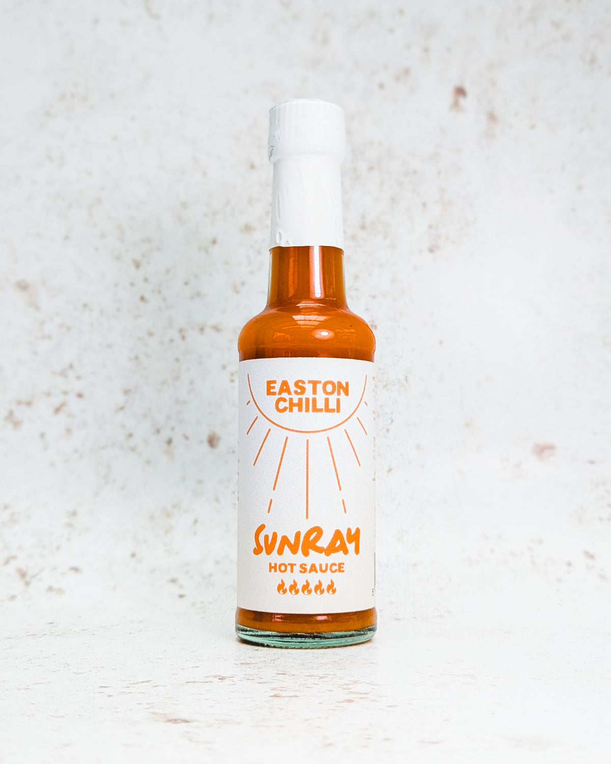 Easton Chilli Sunray hot sauce bottle featuring kumquat, habanero, and scotch bonnet peppers on the label.