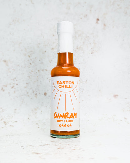 Easton Chilli Sunray hot sauce bottle featuring kumquat, habanero, and scotch bonnet peppers on the label.