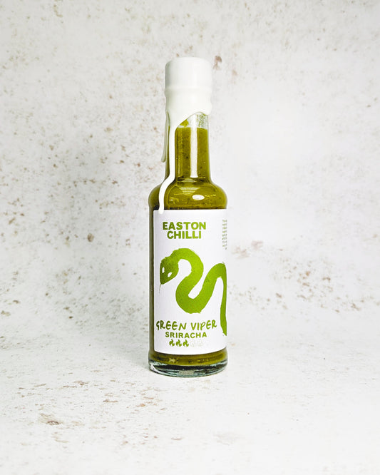 Green Viper Sriracha hot sauce by Easton Chilli, featuring a vibrant green chili pepper in a clear glass bottle.