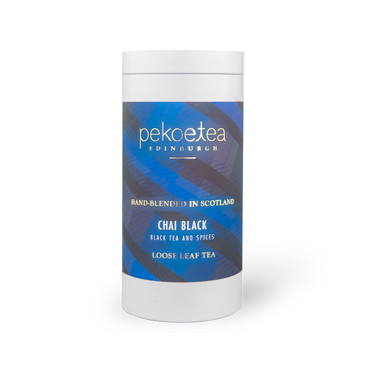 Loose leaf PekoeTea Edinburgh Chai Black Tea in a caddy, showcasing aromatic dark tea leaves for brewing flavorful chai.