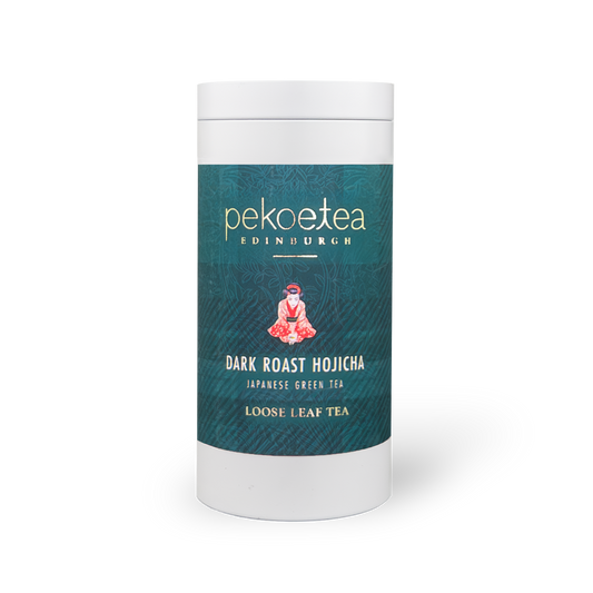 Dark roast Hojicha tea caddy by PekoeTea Edinburgh with a brown and gold packaging design, showcasing the tea's rich, roasted appearance.