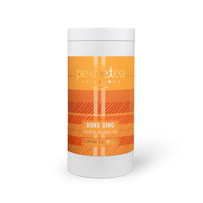 Fujian Dong Ding Oolong Tea in a decorative caddy, featuring loose tea leaves and traditional packaging from PekoeTea Edinburgh.