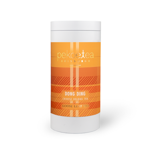 Fujian Dong Ding Oolong Tea in a decorative caddy, featuring loose tea leaves and traditional packaging from PekoeTea Edinburgh.