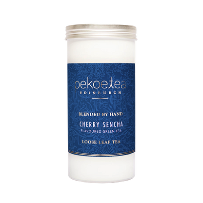PekoeTea Edinburgh Cherry Sencha green tea in a decorative caddy, showcasing vibrant green tea leaves and cherry flavor accents.
