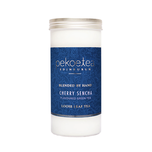 PekoeTea Edinburgh Cherry Sencha green tea in a decorative caddy, showcasing vibrant green tea leaves and cherry flavor accents.