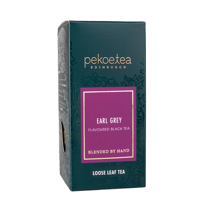 Loose leaf Earl Grey Blue Flower Tea from PekoeTea Edinburgh in a decorative box, showcasing blue flowers and fragrant tea leaves.