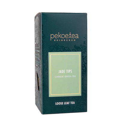 Loose leaf Xin Yang Mao Jian green tea with jade-tipped leaves in a PekoeTea Edinburgh box, showcasing fresh, high-quality tea leaves.