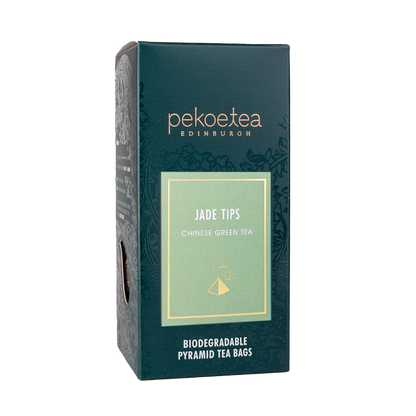 Box of PekoeTea Edinburgh Xin Yang Mao Jian Jade Tips green tea teabags with fresh green tea leaves inside.