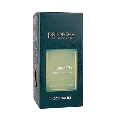 Loose leaf tea box labeled The Orangery by PekoeTea Edinburgh, featuring elegant packaging with tea leaves inside.