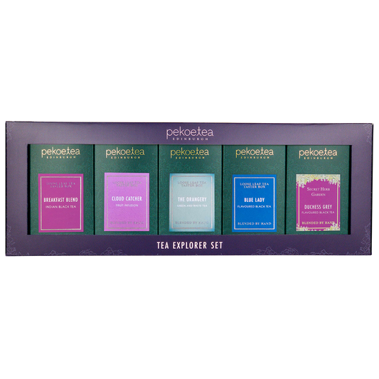 PekoeTea Edinburgh Explorer Set featuring five assorted tea tins with colorful labels and a wooden tray for tea tasting.