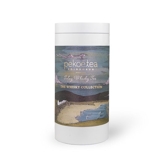 PekoeTea Edinburgh Islay Blend whisky tea in a decorative caddy featuring a label and tea leaves inside.