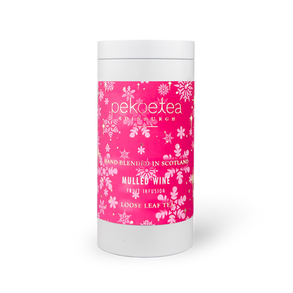 Caddy of PekoeTea Edinburgh mulled wine flavored tea, featuring a decorative tin with tea bags inside.