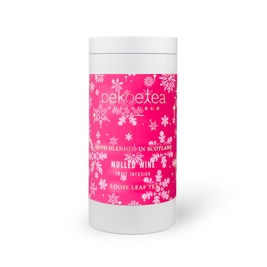 Caddy of PekoeTea Edinburgh mulled wine flavored tea, featuring a decorative tin with tea bags inside.
