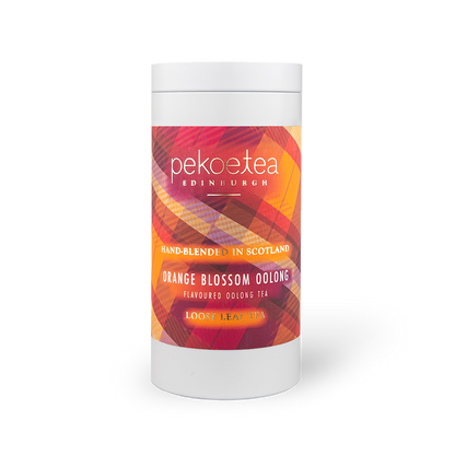 Orange Blossom Oolong Tea in a PekoeTea Edinburgh caddy, showcasing the elegant tea packaging with orange blossom floral accents.