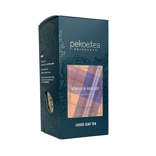 Loose leaf tea box labeled Newhaven Harbour by PekoeTea Edinburgh, featuring a detailed design inspired by the harbor scene.