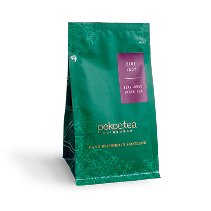Blue Lady flavored black tea by PekoeTea Edinburgh in a retail pouch, featuring vibrant blue packaging and tea leaves inside.