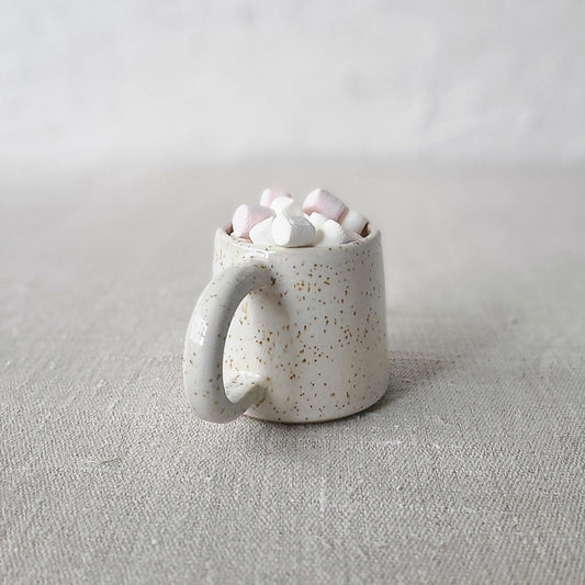 White ceramic Pepper White Classic Espresso Mug by Katie L Thompson Designs filled with marshmallows, close-up of mug on a surface.
