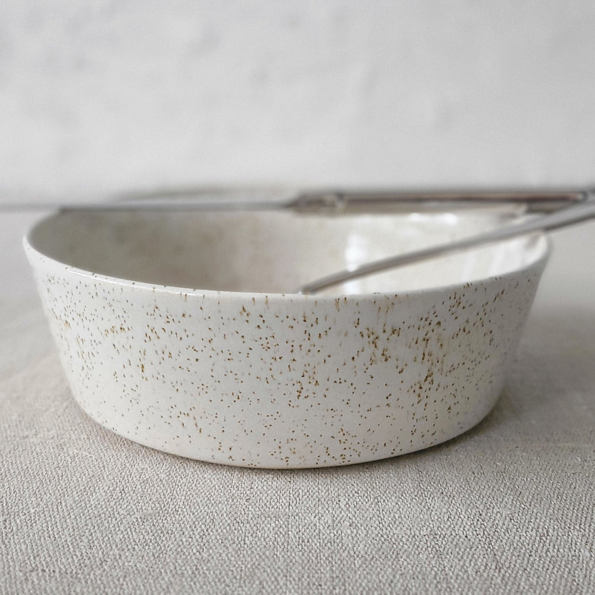 Pepper White Classic Pasta Bowl by Katie L Thompson Designs with a knife and fork on a white background.