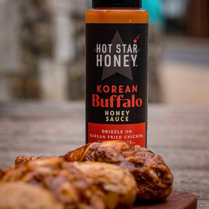 Spicy Korean Buffalo Honey Sauce by Hot Star Honey drizzled over crispy chicken wings for Asian-inspired flavor.