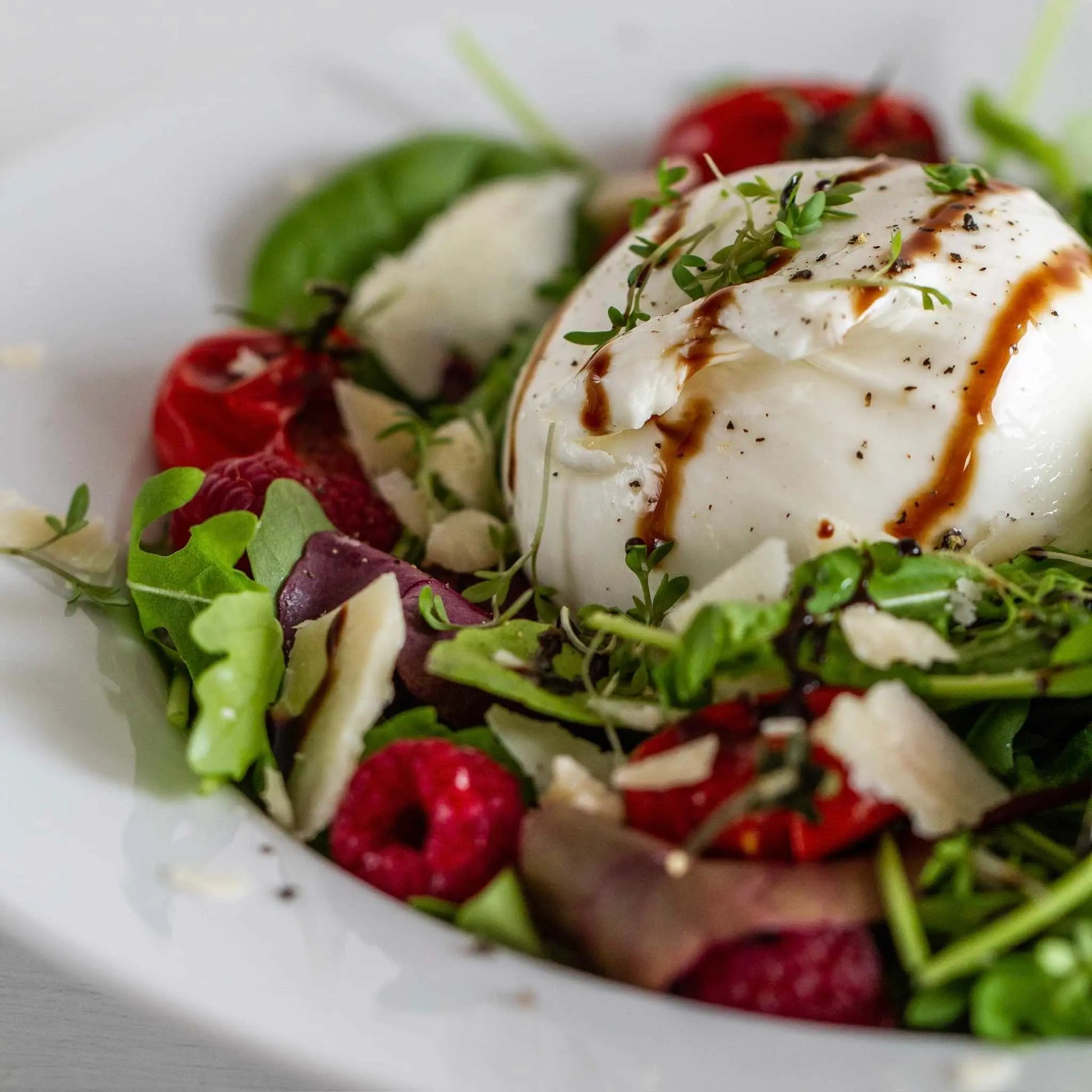 Hot Star Honey Classic Balsamic Honey Glaze drizzled on a fresh salad, showcasing its rich, glossy balsamic and honey combination.