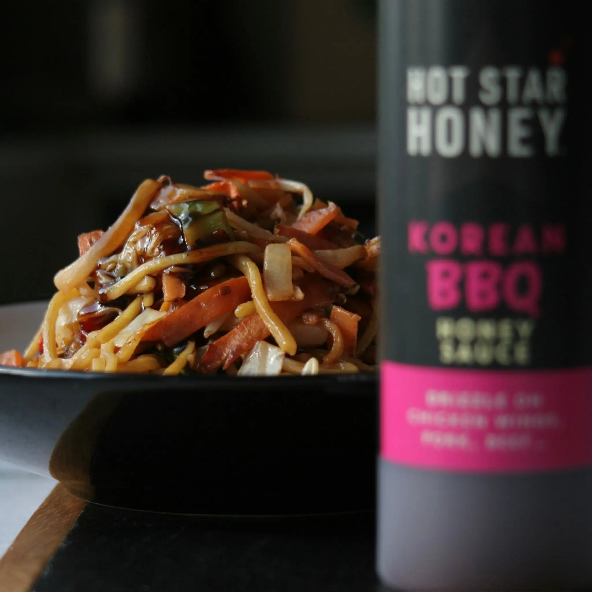 Hot Star Honey Korean BBQ Sauce on stir-fry, showcasing rich, glossy sauce drizzled over grilled meats and vegetables.