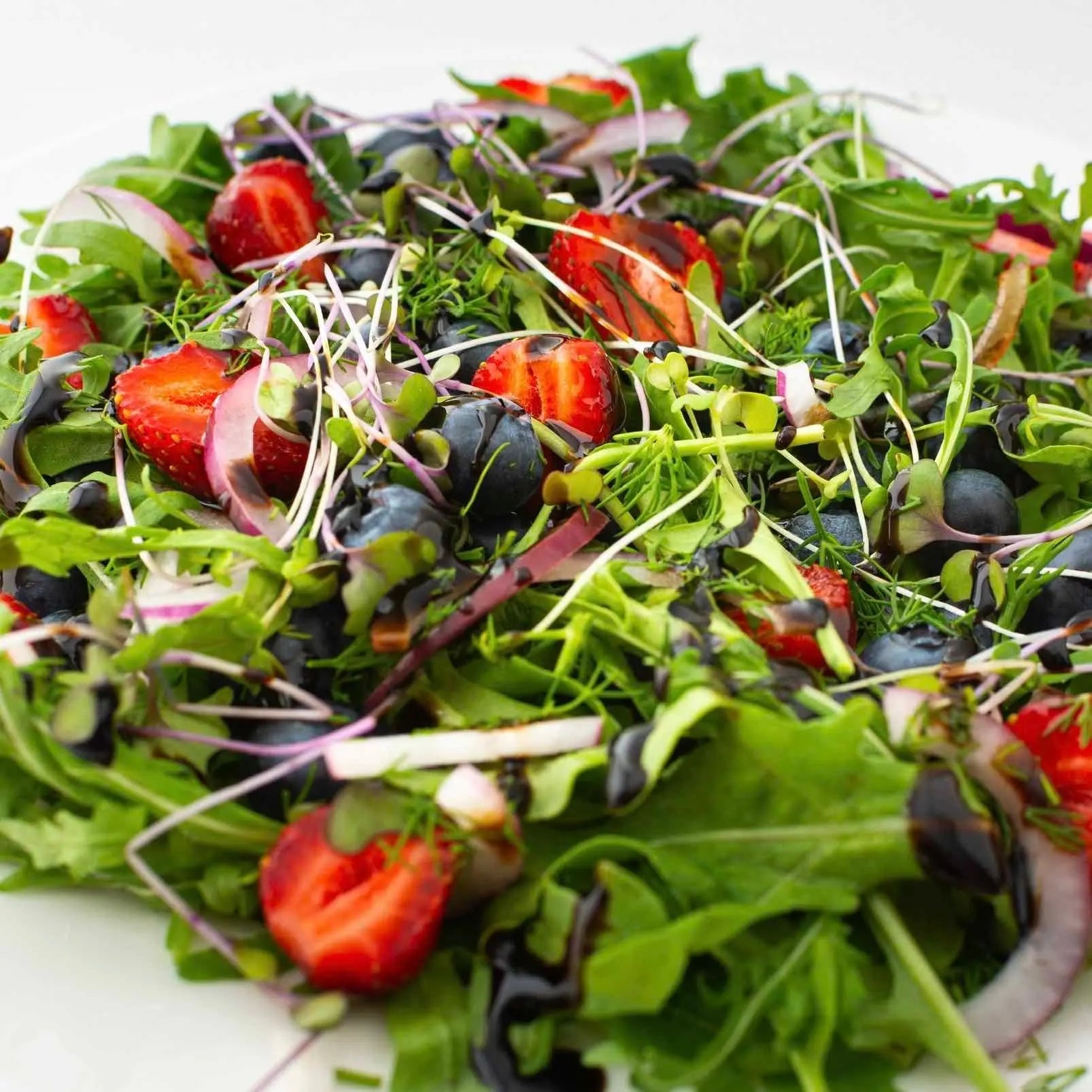 Hot Star Honey Classic Balsamic Honey Glaze drizzled over a fresh salad, showcasing its rich, glossy balsamic glaze texture.