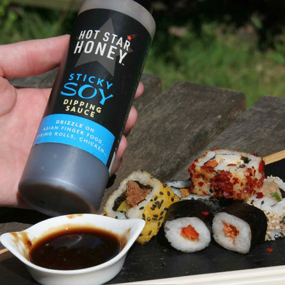 Asian-inspired Hot Star Honey sticky soy dipping sauce drizzled on sushi, showcasing glossy, flavorful soy glaze on the dish.