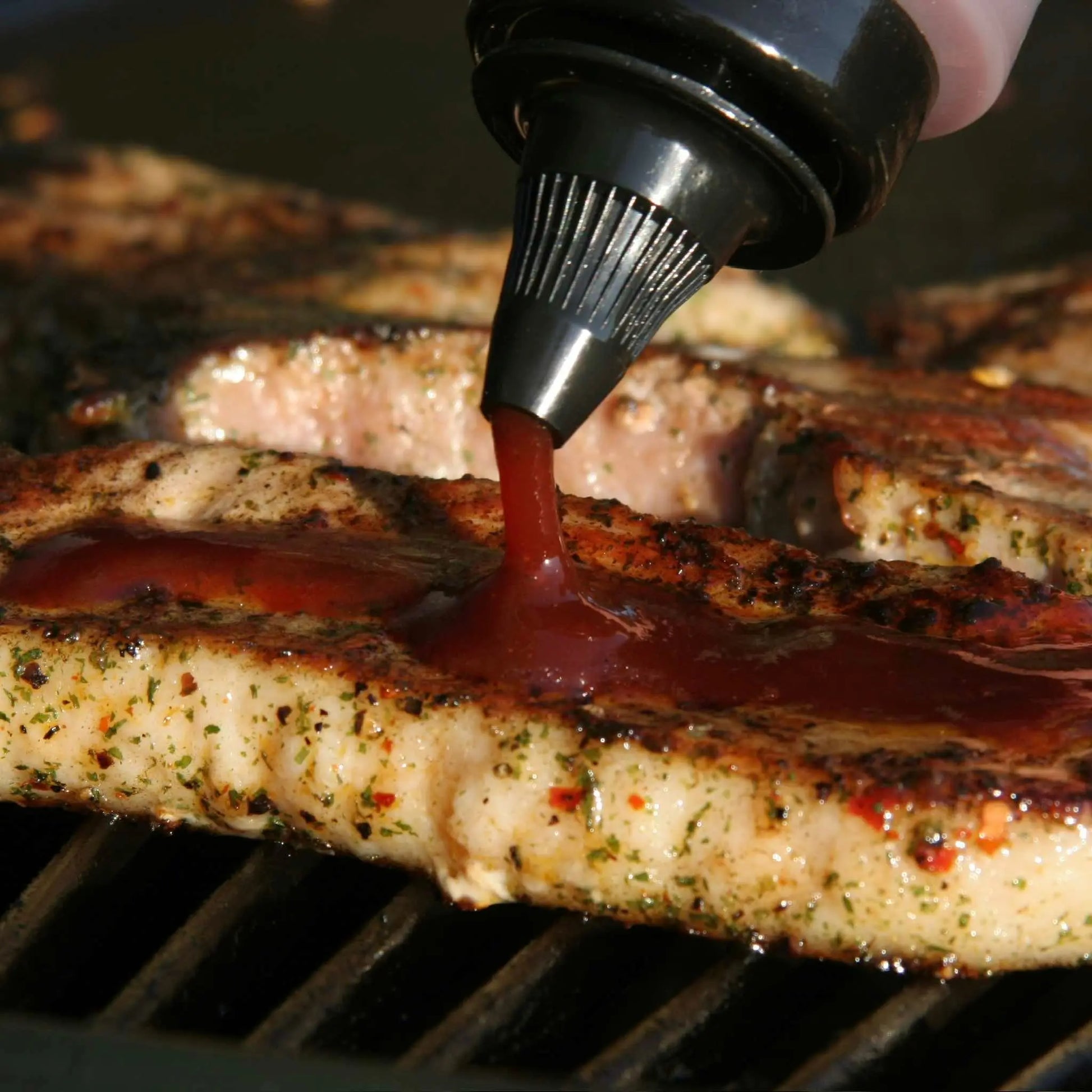 Hot Star Honey Asian Sauce Trio gift set with Korean BBQ sauce bottles on grilled steak, showcasing flavorful Asian condiments.