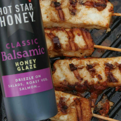 Balsamic honey glaze drizzled over grilled halloumi cheese on a white plate, showcasing Hot Star Honey's classic balsamic glaze.
