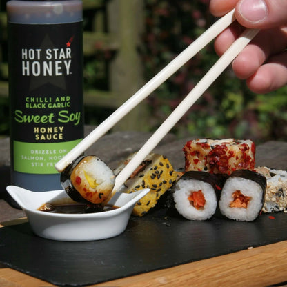Asian-inspired hot star honey sweet soy sauce drizzled on sushi with chili and black garlic flavors