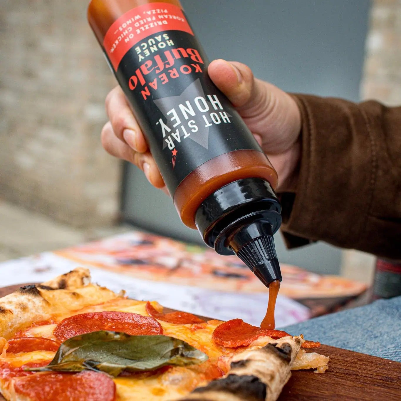 Korean Buffalo Honey Sauce on pizza showing a close-up of the spicy, sweet Asian-inspired sauce drizzled over toppings