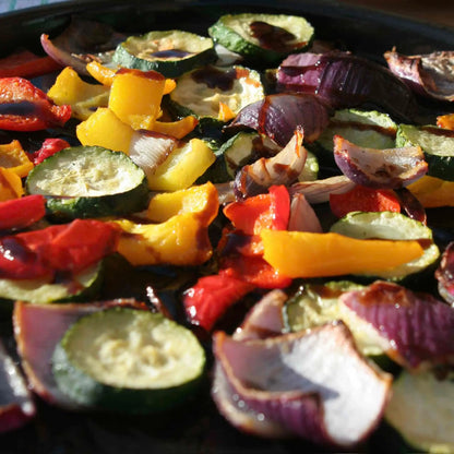 Hot Star Honey Classic Balsamic Honey Glaze drizzled over roasted vegetables, showcasing its rich, glossy balsamic glaze texture.