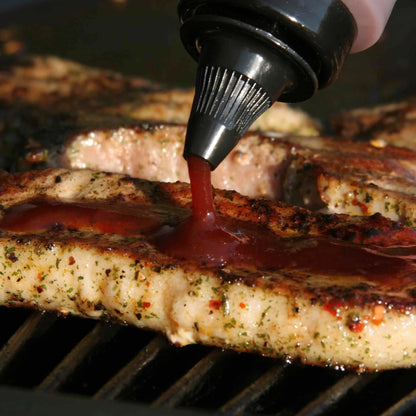 Hot Star Honey Caribbean BBQ Honey Sauce drizzled on grilled meat, showcasing its rich, sweet, and smoky flavor.