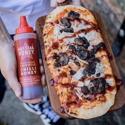 Hot Star Honey Chipotle Chilli Honey drizzled on pizza, showcasing its spicy, smoky flavor and glossy amber appearance.
